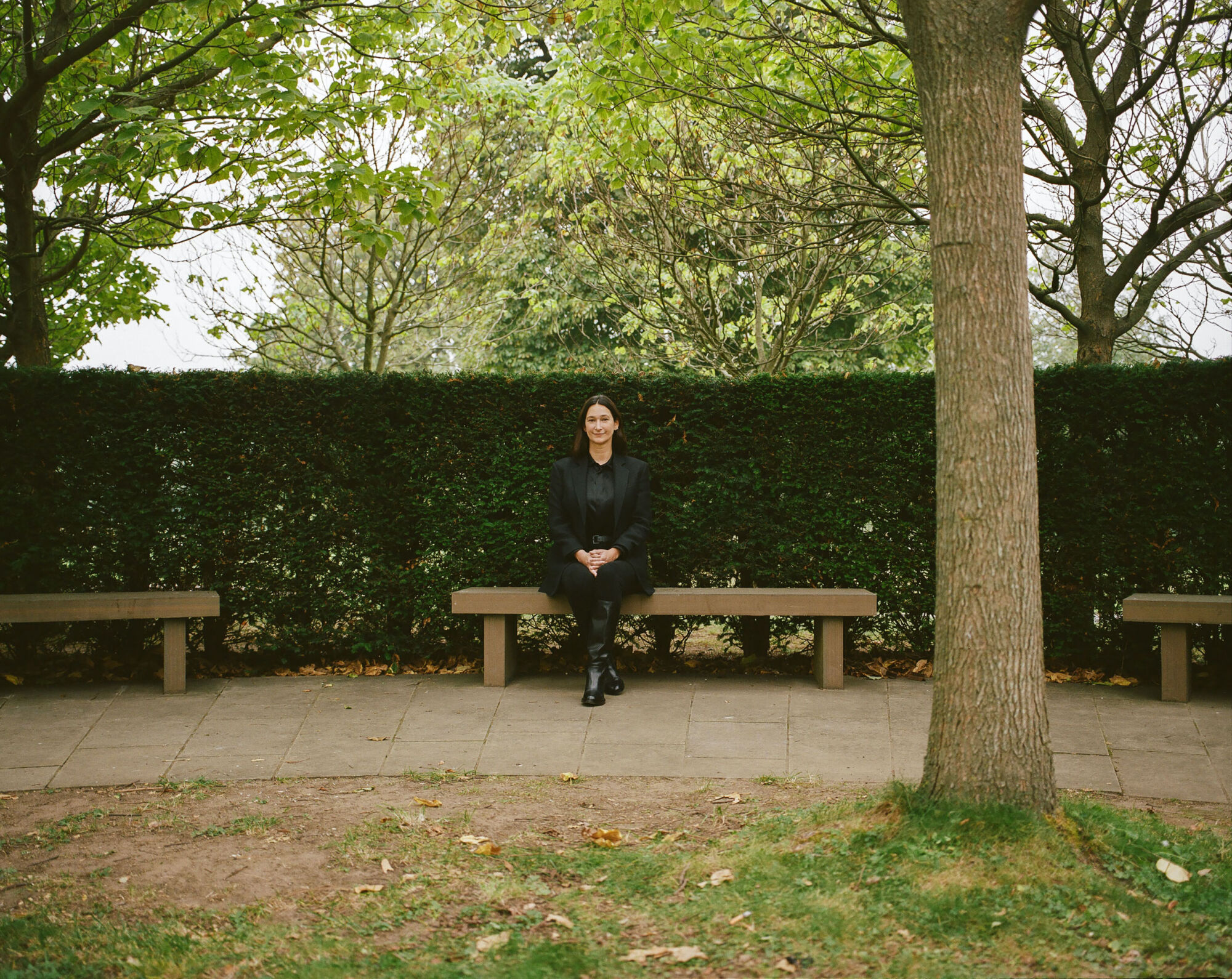 The Wick - Bettina Korek, Serpentine Chief Executive
Photographed by Rosie Matheson, September 2020 in the grounds of the Serpentine Gallery, Kensington Gardens, London.
 
Images 20, 23, 25 include a bench which is part of a permanent commission by the Scottish poet and artist Ian Hamilton Finlay.

Installed in 1998, the work comprises eight benches, a tree-plaque, and a large, complex inscription at the Gallery’s entrance.