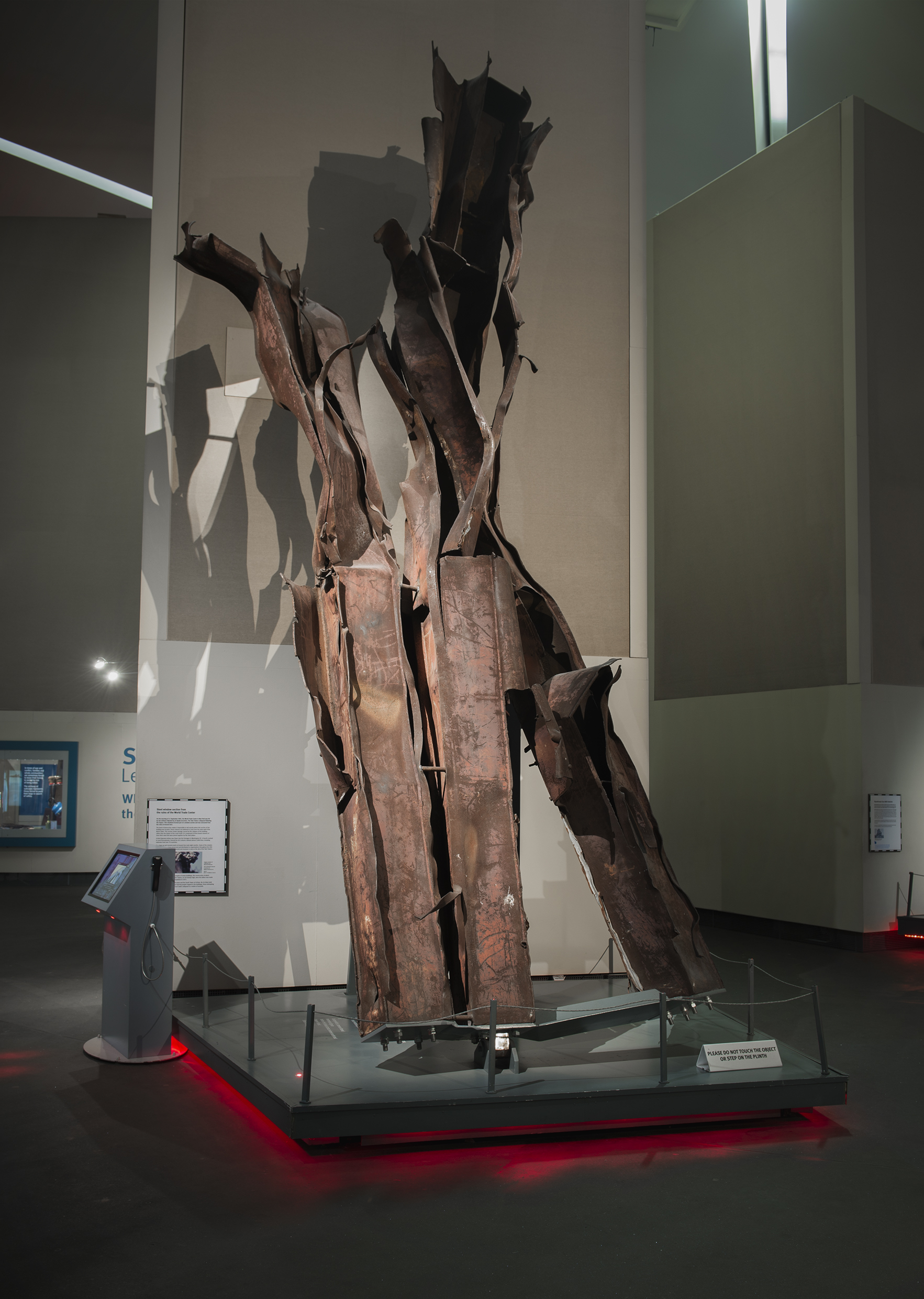 The Wick - General view of Section of steel work, (Obj No EPH 10364.1) from one of the Twin Towers involved in the 911 terrorist attack in New York, in the Main Exhibition Space at IWM North. Section of twisted and rusted steelwork from the collapsed World Trade Center, New York.   The twin towers, which opened on 4 April 1973, were at the time of their construction the tallest buildings in the world.   On the morning of 11 September 2001, hijackers affiliated with the Al-Qaeda organisation flew two Boeing 767 jets into the complex, beginning with the North Tower at 8:46am, then the South Tower 17 minutes later, in a coordinated act of terrorism.  After burning for almost an hour, the South Tower collapsed, followed by the North Tower 29 minutes later.  The attacks on the World Trade Center killed 2,606 people in and within the vicinity of the towers, as well as all 157 on board the two aircraft.  This particular piece of steelwork comprises beams from the external walls of the building, and was originally located somewhere around one of the two impact zones. Photographed 24th January 2017.