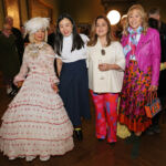 A diverse group of four women pose for a picture together at Tim Yip's art film Love Infinity screening, all stylishly dressed.