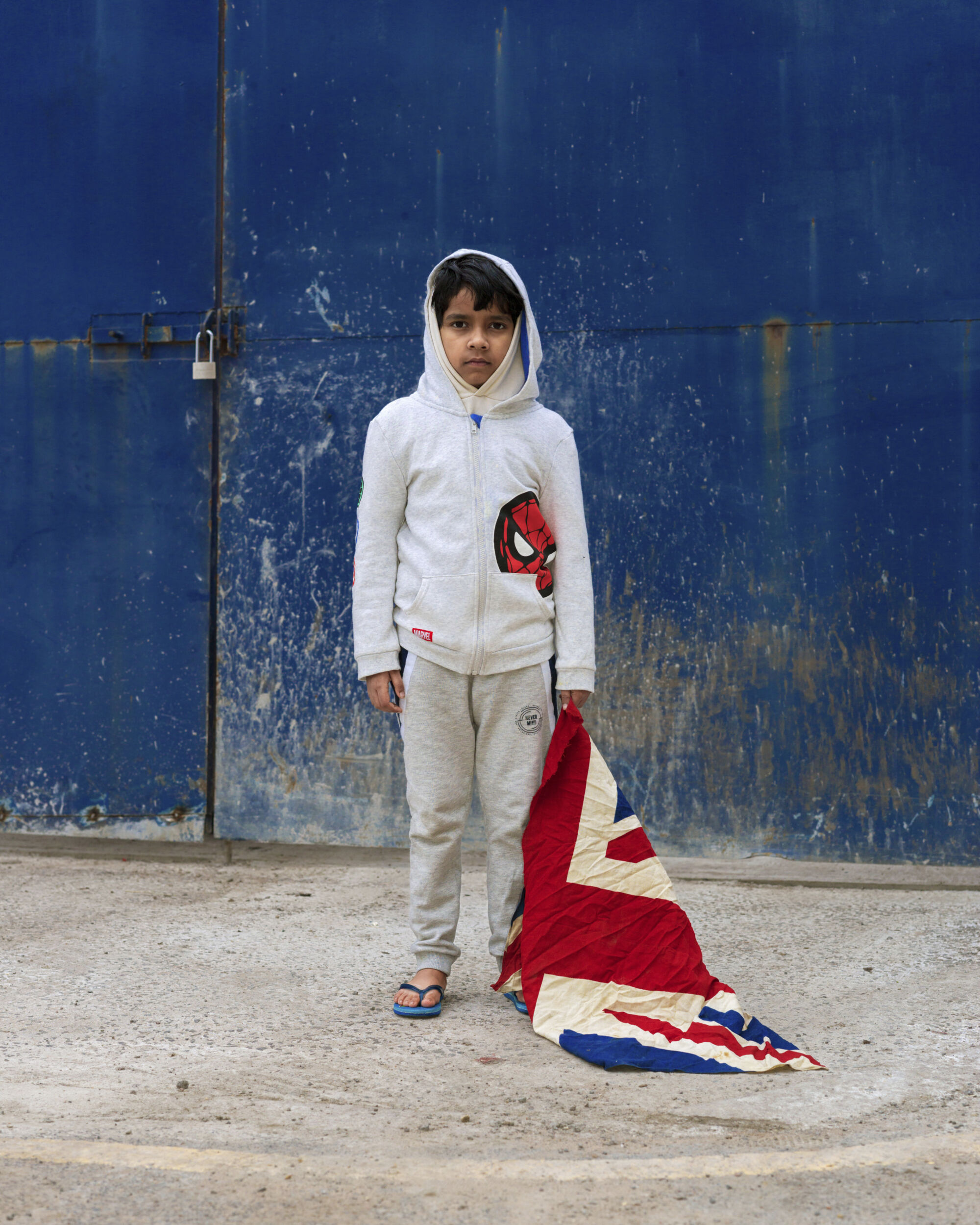 The Wick - Boy with the Union Flag, March 2021. From the series This Golden Mile by Kavi Pujara © Kavi Pujara
