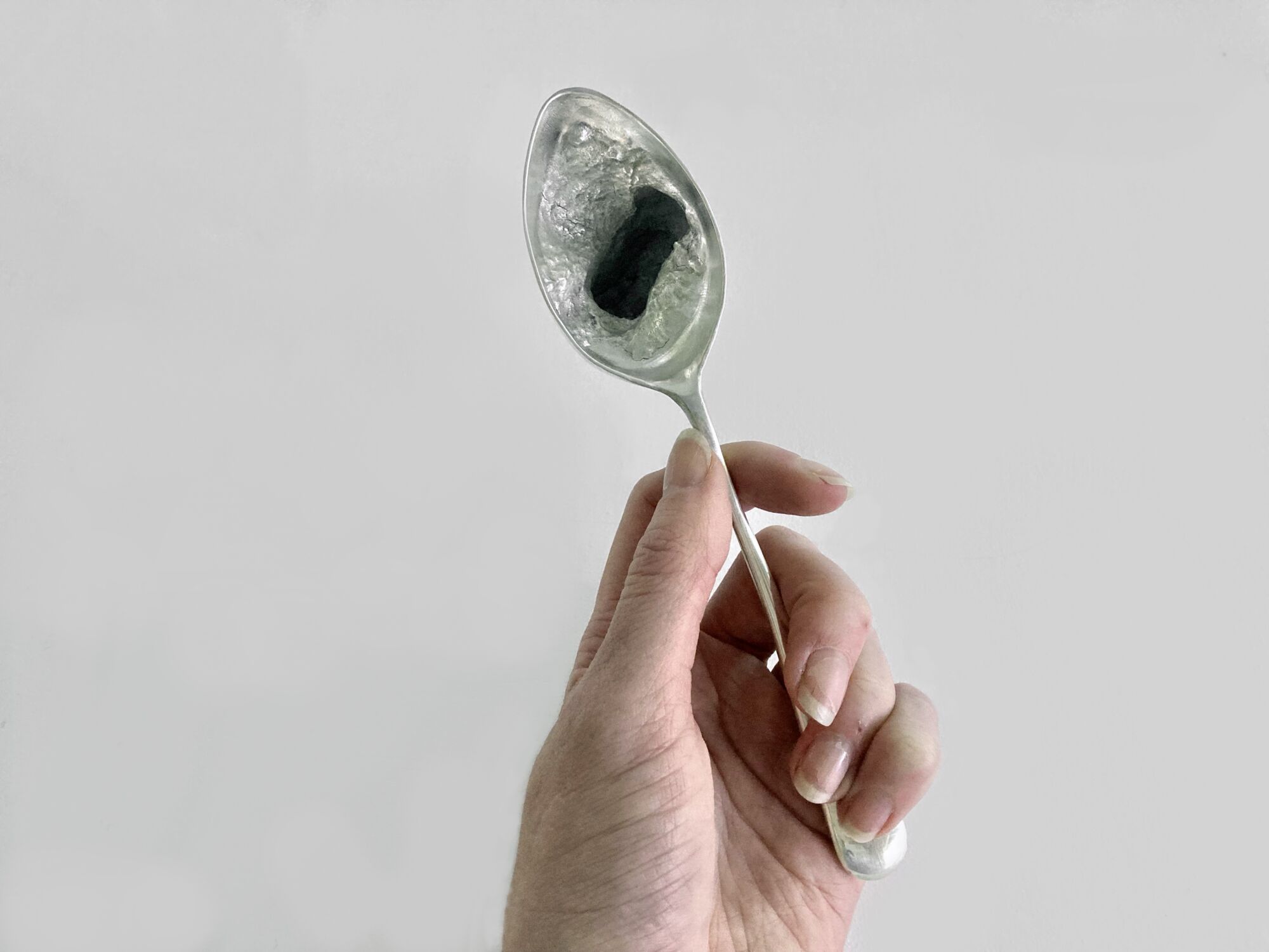 The Wick - holding spoon, Courtesy of the Artist