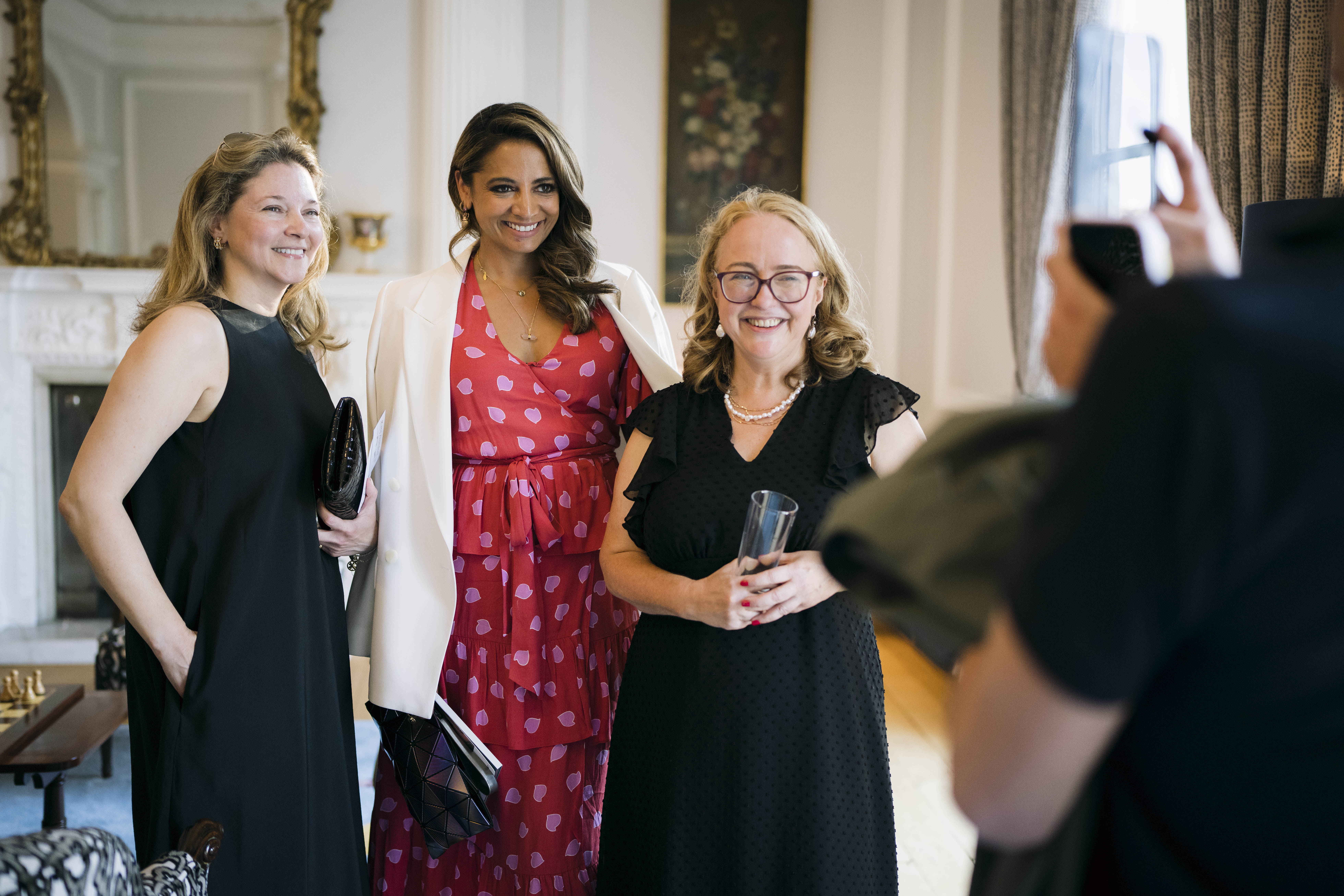 The Wick - Rose Aidin and Katy Wickremesinghe and AHLU trustee Kate Gordon being photographed by Will Iron, at Belgian Ambassador_s Residence Event for AHLU, June 2023, Photo Scott Garfitt.JPG