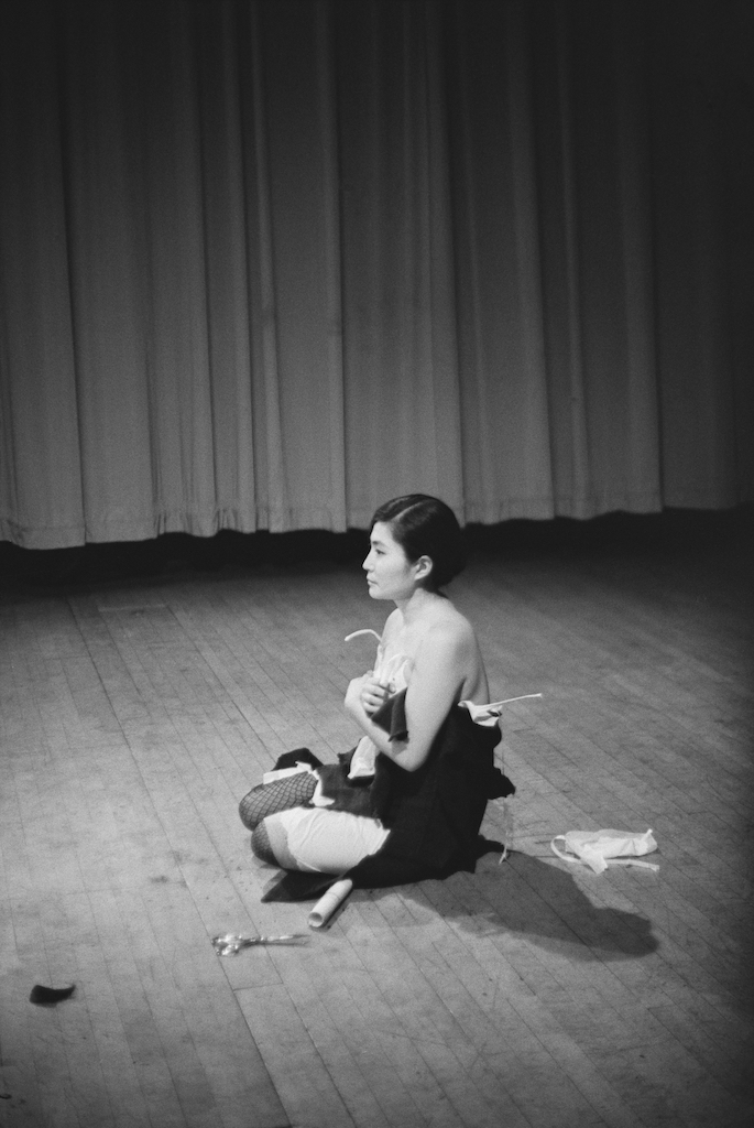 The Wick - Yoko Ono, Cut Piece 1964. Performed by Yoko Ono in ‘New Works by Yoko Ono’, Carnegie Recital Hall, NYC, March 21 1965. Photo © Minoru Niizuma