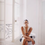 Woman sitting on chair in front of a window