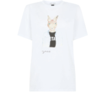 White t-shirt by Bella Freud with a cartoon bunny looking straight at the viewer, wearing a black t shirt and blue button down over it.