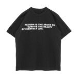 Black t shirt by Bill Cunningham against a white background with text that reads "FASHION IS THE ARMOR TO SURVIVE THE REALITY OF EVERYDAY LIFE."