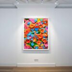 A bright painting by Rob and Nick Carter hangs on a white gallery wall. The painting features a range of multicolours.