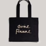 A black tote bag from Marks and Spencer with the words 'divine feminine' on it.
