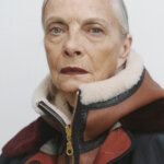 Older white woman, Jan de Villeneuve, with grey hair looking at camera wearing a earth tone winter jacket