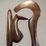 A bronze sculpture of an abstract form