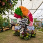 A figure with a mohawk made out of flowers