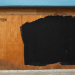 A photograph the side of a building with black