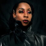A Black woman wearing a black leather jacket