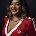 Woman wearing a red adidas top