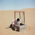 Man looking at the water level in the well