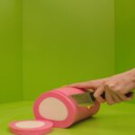A piece of pink meat being cut