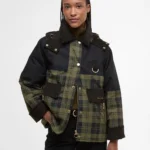 A woman wearing a tartan jacket