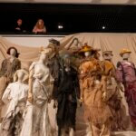A photograph of clothes on a stage on a mannequin