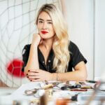 An asian woman with blonde hair wearing red lipstick