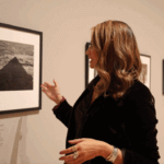 A woman with brown hair looking at photographs