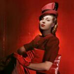 A woman wearing a red outfit and hat