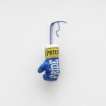 A blue boxing glove hanging from the wall