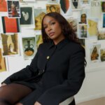 A photo of a Black woman sitting in a chair