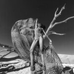 Black and white photograph of a woman on a beach