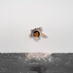 Artwork of a mouse coming through a wall.