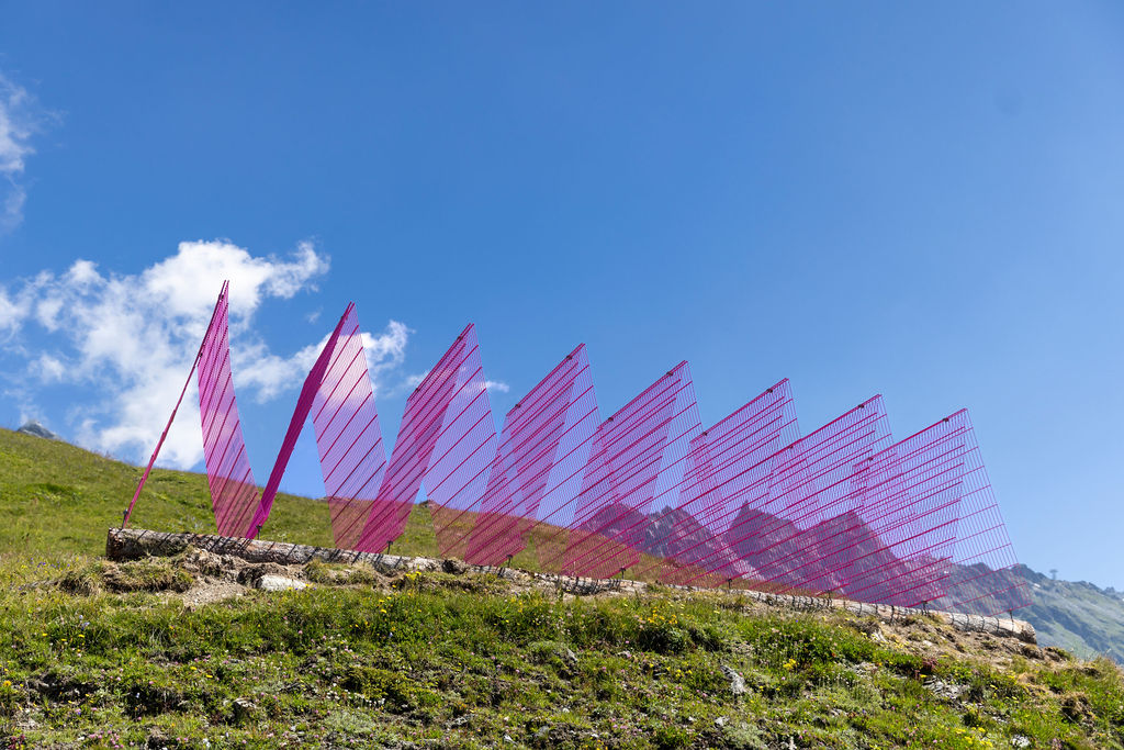 The Wick Culture - Rana Begum, 'No. 1387 Fence', 2024, powder-coated fencing, local wooden logs. Installation view, Verbier 3-D Foundation Sculpture Park, Valais, Switzerland. Photo: Melody Sky. 