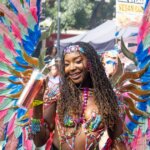 Notting Hill Carnival 2023 parade dancer in vibrant feathered wings. London, UK, 28 August 2023